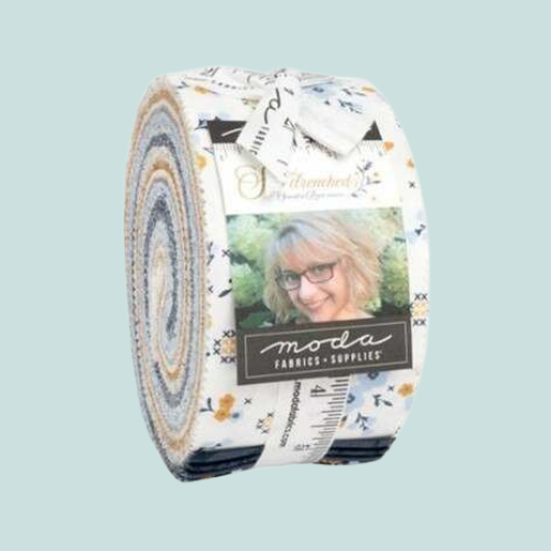Fabric roll with Moda Fabrics branding on a light blue background