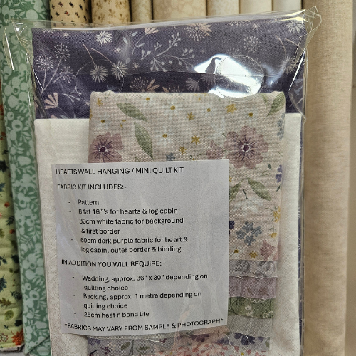 Fabric kit for a mini quilt with floral patterns and packaging details.