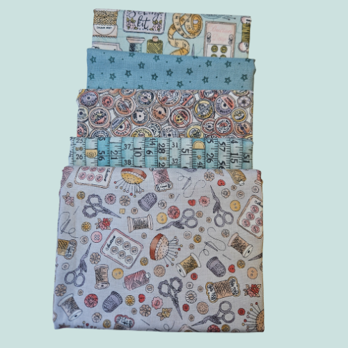 Set of four fabric swatches with sewing-themed patterns on a light blue background