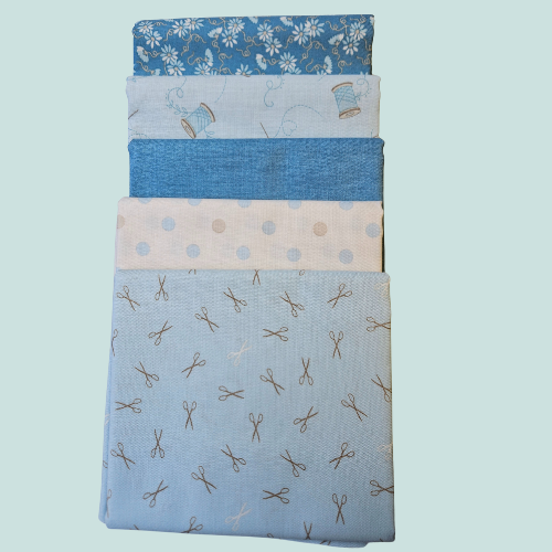 Stack of blue fabric swatches with various patterns on a light blue background