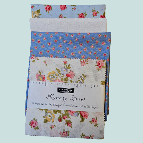 Collection of floral fabric swatches with a ruler on a light blue background