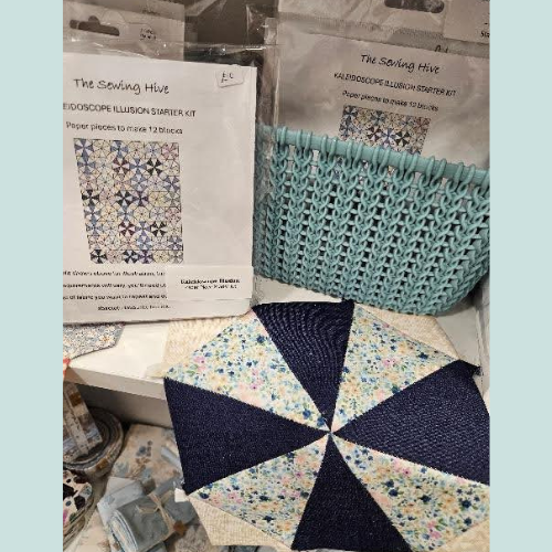 Quilted fabric piece with geometric pattern and 'The Sewing Hive' packaging in the background.